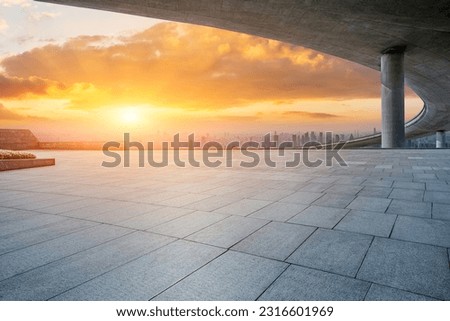 Empty square floor and city skyline with modern buildings at sunset 