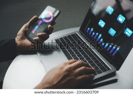 Businessman analyzing the financial data of the company on the laptop using business analytics software. Corporate strategy for finance, operations, sales, marketing is the key. Royalty-Free Stock Photo #2316603709