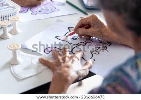 Elderly painting works of cartoon artwork as a hobby activity for exercise hand and brain.