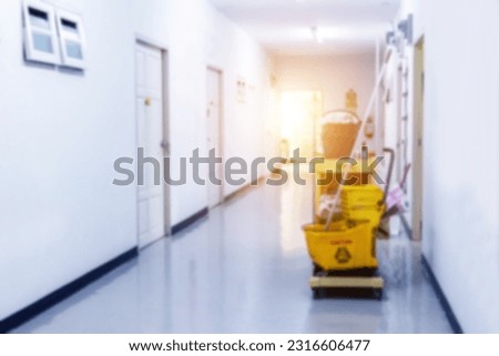 Janitor cart in hallway office building or walkway of hotel or hospital with sun light background blurred image for commercial background.  Royalty-Free Stock Photo #2316606477
