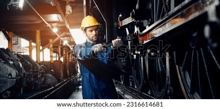 Engineer railway wearing safety uniform and helmet under checking under train ,wheels and control system for safety travel passenger. Banner cover design. Royalty-Free Stock Photo #2316614681