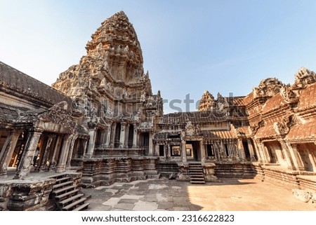 Upper gallery and one of towers at main Temple Mountain of ancient temple complex Angkor Wat in Siem Reap, Cambodia. Angkor Wat is a popular tourist attraction. Royalty-Free Stock Photo #2316622823