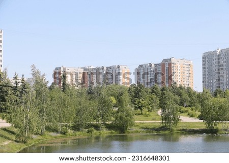 Landscape with a river, trees and blue sky in the urban landscape park Yuzhnoye Butovo, Moscow, June 2023