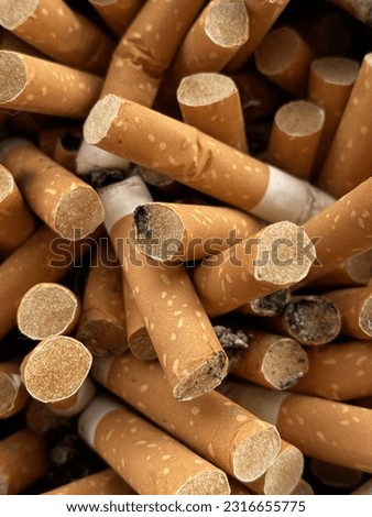 A picture of a pile of cigarette butts smoked every day.