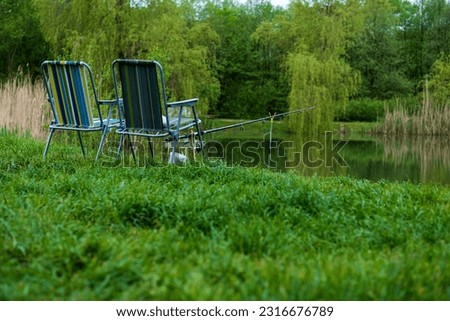 Fishing tackle - fishing spinning, hooks and lures on the background of the river. sport fishing.