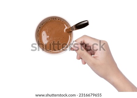 Hand hold ceramic cup of hot chocolate cocoa drink isolated on white background. Top view. Flat lay. 