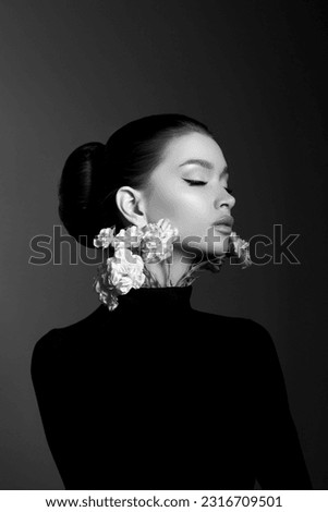 Perfect art woman in black turtleneck on a dark background. Brunette long hair is pulled into a bun. Evening makeup Royalty-Free Stock Photo #2316709501