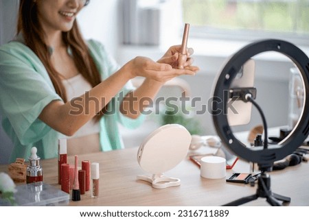 Young Asian girl makeup artist Professional Woman blogger vlogger is showing cosmetics products with recording video Beauty influencer asian girl video online marketing Royalty-Free Stock Photo #2316711889