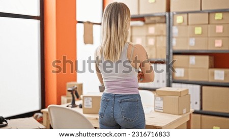 Young blonde woman ecommerce business worker standing with arms crossed gesture backwards at office