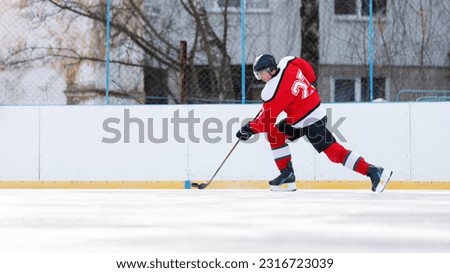 Hockey player with puck on the rink. Image with copyspace.