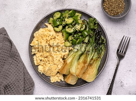 Food photography of breakfast; scrambled egg; fried; crispy; bok choy; cucumber; leaf; brunch