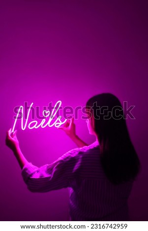 Beautiful girl with neon signs. Pink neon sign nails. Trendy style.  Neon sign. Custom neon. Beauty decor.