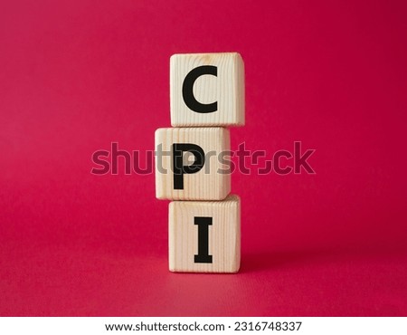 CPI - Consumer Price Index symbol. Concept word CPI on wooden cubes. Beautiful red background. Business and CPI concept. Copy space. Royalty-Free Stock Photo #2316748337