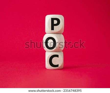 POC - Proof of Concept symbol. Wooden cubes with words POC. Beautiful red background. Business and POC concept. Copy space.