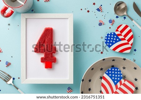Gear up for festive Fourth of July in USA by setting creatively decorated table. Capture top view emblematic embellishments, plate, silverware, mug, number four candle, confetti on light blue backdrop