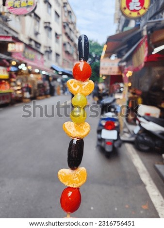 Tang Hu Lu is the name of this. There is a lot of sugar-coated fruit in it. It's a really delicious sweet from a market in Taiwan.



 Royalty-Free Stock Photo #2316756451