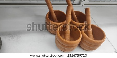 Wooden mortar and stone mortar for pounding spices traditionally or manually.  Mortar stones