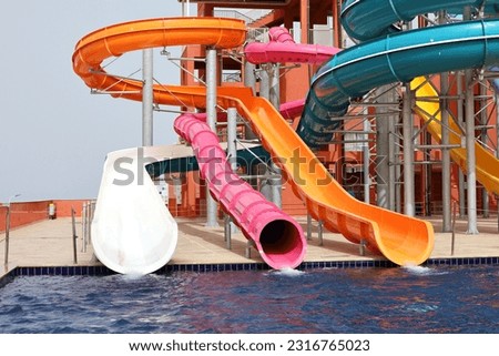 Water slides and swimming pool in aqua park. Amusement park on tourist resort
