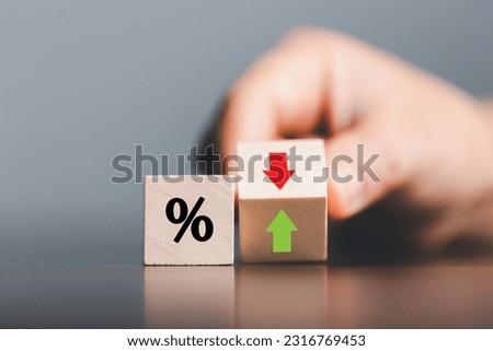 Closeup wood cubes with percentage symbol, Percent and upwards increasing arrows on wooden cubes. Financial interest mortgage rates increase or price commission raise, growth business, finance tax. Royalty-Free Stock Photo #2316769453
