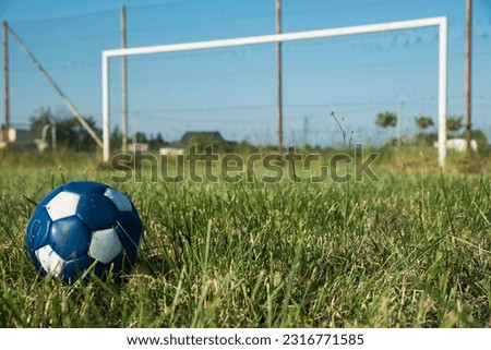 football against the background of a disused league field on a sunny day