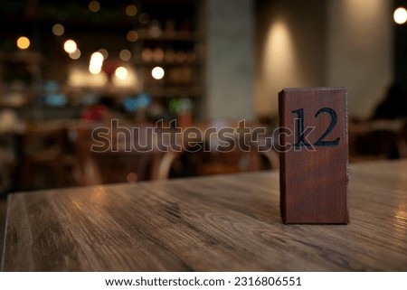 Wooden block table 12 number in a cafe Royalty-Free Stock Photo #2316806551