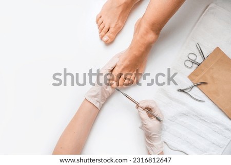 Pedicure, podologist. Patient on medical pedicure procedure, nail disease, cholesis detachment of the nail plate. Foot care, treatment in a medical spa salon. Royalty-Free Stock Photo #2316812647