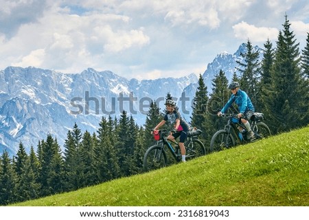 active senior couple on a mountain bike tour in the Julian Alps above Kranska Gora in Slovenia