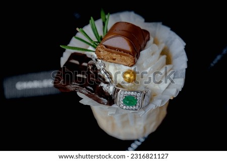 cup cake on wood shelf with wedding ring in wedding ceremony and birthday party.concept for food and desert in party.vertical image