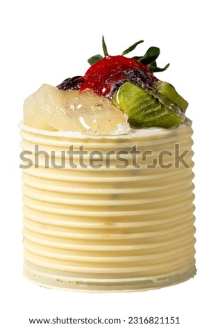 Cream cake surrounded by chocolate. Chocolate and fruit cake isolated on white background. Studio shoot. Bakery products. Close up