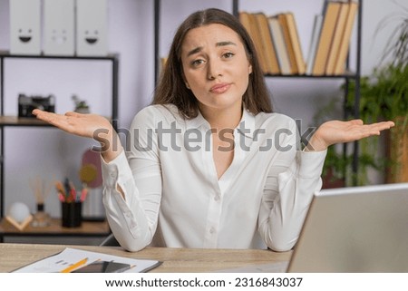 I dont know what to say. Confused business woman works on laptop at office workplace. Freelancer feeling embarrassed about ambiguous question, having doubts, no answer idea, being clueless, uncertain Royalty-Free Stock Photo #2316843037