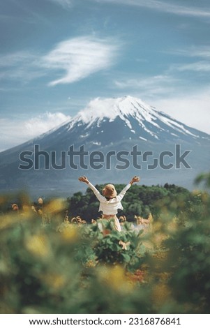 Happy tourist traveler woman enjoying with open arms on lake kawaguchiko with mount fuji in japan, spring and summer, Japan travel vacation