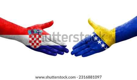 Handshake between Bosnia and Croatia flags painted on hands, isolated transparent image.