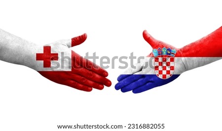 Handshake between Croatia and Tonga flags painted on hands, isolated transparent image. Royalty-Free Stock Photo #2316882055