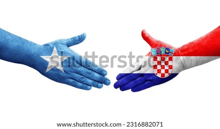 Handshake between Croatia and Somalia flags painted on hands, isolated transparent image.