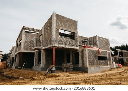 house under construction with autoclaved aerated concrete block structure at building site	 Royalty-Free Stock Photo #2316883601