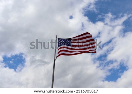 The american flag waving in the wind.