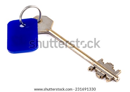 Photo of steel key with blue trinket on white background