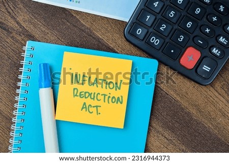 Concept of Inflation Reduction Act write on sticky notes isolated on Wooden Table.