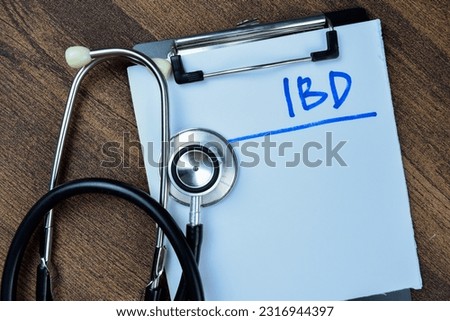 Concept of Ulcerative Colitis write on paperwork isolated on Wooden Table.