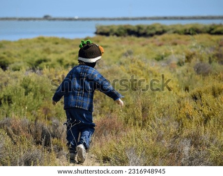 A happy child playing in the middle of Ebro delta, Catalonia.