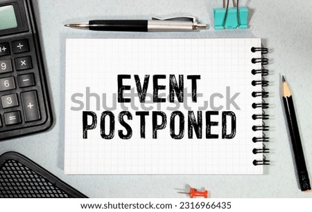 Daily planner with the entry Event postponed. Royalty-Free Stock Photo #2316966435
