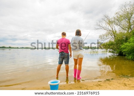 couple fishing together on the river