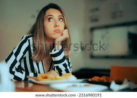 
Bored Woman Sitting in a Restaurant Not Eating her Food. Picky eater hating the service in a diner refusing to eat 
 Royalty-Free Stock Photo #2316980191