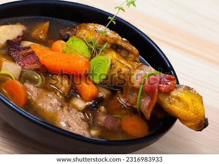 Cock-a-leekie - Scotland national chicken soup with leeks served in black bowl.. Royalty-Free Stock Photo #2316983933