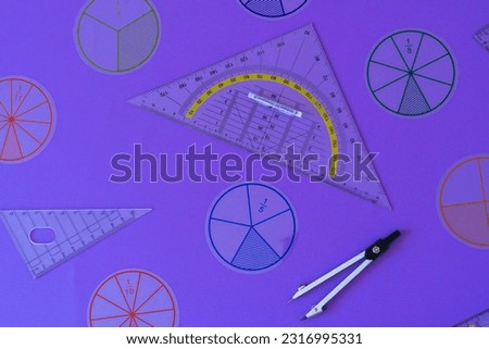 Fractions, rulers on violet background. Set of supplies for mathematics and for school. Back to school, fun education concept. Geometry background	