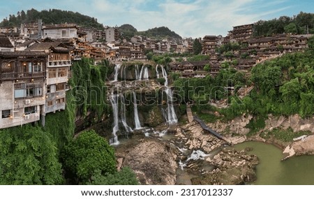 Beautiful ancient town in China with waterfall and traditional houses Royalty-Free Stock Photo #2317012337