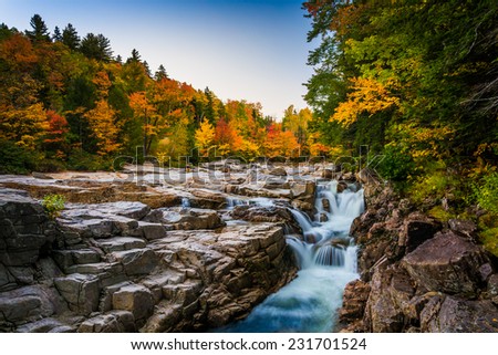 Autumn color and waterfall at Rocky Gorge, on the Kancamagus Highway, in White Mountain National Forest, New Hampshire. Royalty-Free Stock Photo #231701524