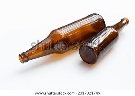 Empty brown bottles on white background.