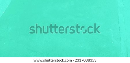 The texture of the green paint cement wall, the background of the green paint cement wall, taken a close-up angle