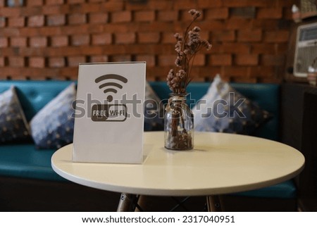 free wi-fi. area sign. Coffee shop. On a circular table. Blurred background. Pastel colors. Royalty-Free Stock Photo #2317040951